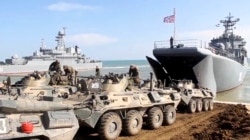 UKRAINE -- Russian military's armored vehicles roll into landing vessels after drills in Crimea, April 23, 2021. (Russian Defense Ministry/AP)