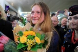 RUSSIA -- Convicted Russian agent Maria Butina, who was released from a Florida prison and then deported by U.S. immigration officials, holds flowers upon her arrival at Sheremetyevo International Airport outside Moscow, Russia October 26, 2019.