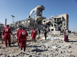 Yemen-- Red Crescent medics stand at the site of Saudi-led air strikes on a Houthi detention centre in Dhamar, September 1, 2019