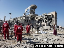 Yemen-- Red Crescent medics stand at the site of Saudi-led air strikes on a Houthi detention centre in Dhamar, September 1, 2019