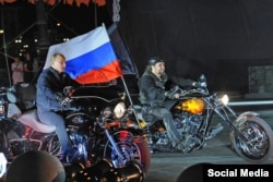 Russian President Vladimir Putin riding alongside the leader of the Night Wolves Alexander Zaltostanov aka the Surgeon