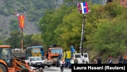 Kosovo ethnic Serbs pass through barricades near the border crossing between Kosovo and Serbia in Jarinje, Kosovo, September 28, 2021. REUTERS/Laura Hasani