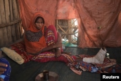 Eysa Mohammed, 15, sits in her house after sustaining injuries on her right leg from an explosive that was left near her house in the aftermath of the fight between the Ethiopian National Defence Force (ENDF) and the Tigray People's Liberation Front (TPLF) forces in Kasagita town, Afar region on February 25, 2022. (Tiksa Negeri/Reuters)