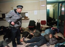 Hungary--Police guard Afghan refugees in Budapest police station on December 15, 1998.