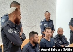 ISRAEL -- Russian citizen Aleksei Burkov (2nd R seated), suspected of hacking-related crimes, attends court a hearing in Jerusalem, November 3, 2019