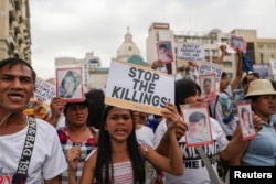 Filipino activists and relatives of people killed in the country's war on drugs hold a rally in observance of Human Rights Day in Manila on December 10, 2019. (Eloisa Lopez/Reuters)