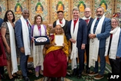 A group of senior U.S. lawmakers including former House speaker Nancy Pelosi (3L) poses with Tibetan spiritual leader the Dalai Lama (C) for photos after a meeting at his residence in Dharamsala, India on June 19, 2024. (Official website of the Dalai Lama/via AFP)