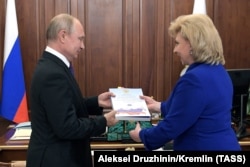 RUSSIA -- Russian Human Rights ombudsman Tatyana Moskalkova gives a report of her work to Russian President Vladimir Putin during their meeting at the Kremlin in Moscow, June 10, 2019