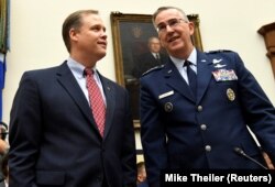 U.S. -- NASA Administrator Jim Bridenstine (L) chats with US Strategic Command Commander Gen. John Hyten before the start of the House Armed Services Strategic Forces Subcommittee's joint hearing with the House Science, Space and Technology Committee.