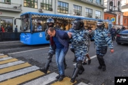 Russia -- special police forces detain a man after a rally urging fair elections in central Moscow on 10 Aug 2019