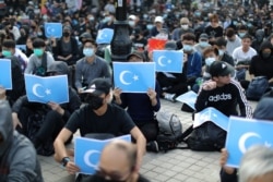 Hong Kong protesters hold East Turkestan Uighur flags at a rally in support of Xinjiang Uighurs' human rights in Hong Kong, China, December 22, 2019.