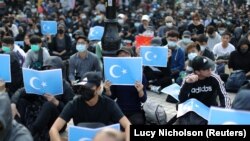 CHINA -- Hong Kong protesters hold East Turkestan Uighur flags at a rally in support of Xinjiang Uighurs' human rights in Hong Kong, China, December 22, 2019. 