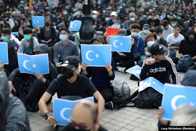 Hong Kong protesters hold East Turkestan Uighur flags at a rally in support of Xinjiang Uighurs' human rights in Hong Kong, China, December 22, 2019.