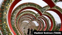 CHECHNYA -- Chechen women walk along a decorated street during a celebration of the City Day in Grozny, October 4, 2018