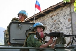 GEORGIA - Russian 'peacekeepers' sit atop their armored vehicle, in an undisclosed location in the breakaway Georgian region of Abkhazia on Tuesday, August 26, 2008