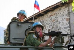 GEORGIA - Russian 'peacekeepers' sit atop their armored vehicle, in an undisclosed location in the breakaway Georgian region of Abkhazia on Tuesday, August 26, 2008