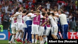 Russia players celebrate winning the penalty shootout against Spain, July 1, 2018.