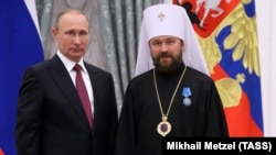 RUSSIA – Russia's President Vladimir Putin (L) awards Metropolitan Hilarion of Volokolamsk with an Order of Honor during a ceremony at the Moscow Kremlin, September 22, 2016.