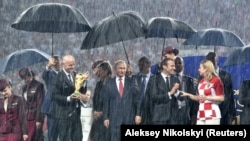 RUSSIA - Russian President Vladimir Putin, French President Emmanuel Macron, Croatian President Kolinda Grabar-Kitarovic and FIFA President Gianni Infantino attend the ceremony of presenting the trophy. Picture taken July 15, 2018. 