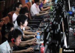 Customers use computers at an internet cafe in Hefei on July 1, 2009. Jianan Yu/Reuters)