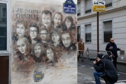 The artwork of French street artist Christian Guemy aka "C215" depicting members of satirical magazine Charlie Hebdo is painted on a facade near the magazine's offices at Rue Nicolas Appert, on Jan. 7, 2020 in Paris.