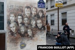 The artwork of French street artist Christian Guemy aka "C215" depicting members of satirical magazine Charlie Hebdo is painted on a facade near the magazine's offices at Rue Nicolas Appert, on Jan. 7, 2020 in Paris.
