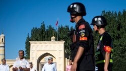 CHINA – Police patrolling as Muslims leave the Id Kah Mosque after the morning prayer on Eid al-Fitr in the old town of Kashgar in China's Xinjiang Uighur Autonomous Region, on June 26, 2017.