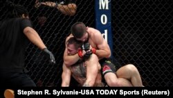 USA-Oct 6, 2018; Las Vegas, NV, USA; Khabib Nurmagomedov (red gloves) fights Conor McGregor (blue gloves) during UFC 229 at T-Mobile Arena. Mandatory Credit: Stephen R. Sylvanie-USA TODAY Sports