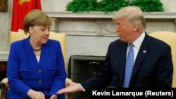 U.S. -- U.S. President Donald Trump greets German Chancellor Angela Merkel in the White House Oval Office in Washington, April 27, 2018