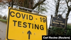 FILE PHOTO: A sign is seen at the coronavirus disease (COVID-19) test center at Stanley Park, near Anfield, on the first day of a newly imposed lockdown, in Liverpool, Britain, November 5, 2020.