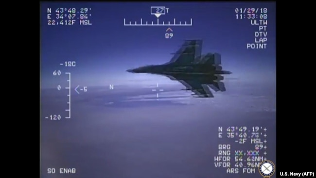 A Russian Su-27 jet is seen in a screenshot from a US Navy video handout flying close to a U.S. reconnaissance plane over the Black Sea on January 29, 2018