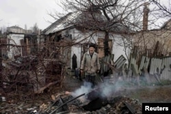 Ukraine -- A man stands in front of his destroyed house in the town of Debaltseve, north-east from Donetsk, March 13, 2015