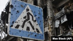 A road sign pierced by shrapnel stands at a new terminal of Donetsk Airport destroyed by shelling, in Donetsk, October 25, 2015. (Max Black/AP)