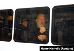 U.K. -- WikiLeaks founder Julian Assange is seen in a police van after was arrested by British police outside the Ecuadorian embassy in London, Britain April 11, 2019.