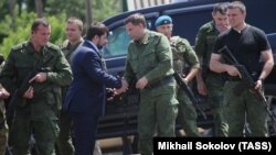 UKRAINE – Denis Pushilin (2nd L front), representative of “DPR”, and Alexander Zakharchenko (2nd R front), head of the “DPR”, attend the commemorative events in memory of the people, who died during Boeing 777 crash on 17 July 2014.