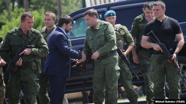 UKRAINE – Denis Pushilin (2nd L front), representative of “DPR”, and Alexander Zakharchenko (2nd R front), head of the “DPR”, attend the commemorative events in memory of the people, who died during Boeing 777 crash on 17 July 2014.