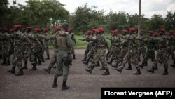 New recruits for the Central African Armed Forces (FACA) march in formation during an award presentation in Berengo, CAR on August 4, 2018.