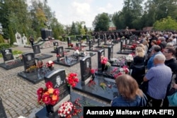 RUSSIA -- Relatives of the deceased crew of the Kursk nuclear-powered submarine attend the memorial ceremony on the 19th anniversary of the Kursk submarine tragedy at the Serafimovskoye cemetery in St. Petersburg, August 12, 2019