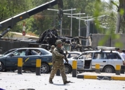 AFGHANISTAN -- A foreign soldier with NATO-led Resolute Support Mission inspects the site of a suicide attack in Kabul, Afghanistan September 5, 2019.