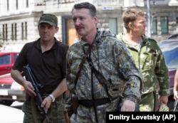 UKRAINE – Igor Girkin (center), also known as Igor Strelkov, a Russian citizen and commander of Kremlin proxy forces in Ukraine in the city of Donetsk, July 11, 2014