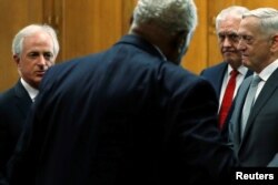 Senate Foreign Relations Committee Chairman Bob Corker (R-TN) (L) arrives with U.S. Secretary of State Rex Tillerson and Defense Secretary James Mattis for their testimony on authorizations for the use of military force, October 30, 2017.