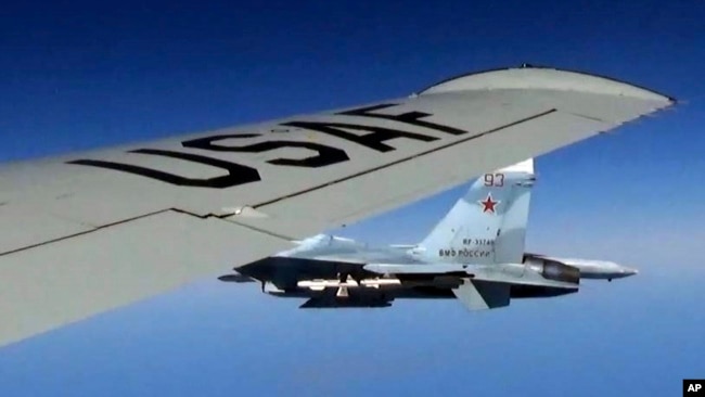 A U.S. RC-135U flying in international airspace over the Baltic Sea, is intercepted by a Russian SU-27 Flanker on June 19, 2017. The Russian military said it scrambled a fighter jet to intercept and escort a U.S. strategic bomber flying over the Baltic.