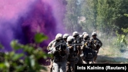 LATVIA -- U.S. soldiers take part in the urban fighting drill during the NATO Saber Strike exercise in the Soviet-time former military town near Skrunda, June 13, 2018