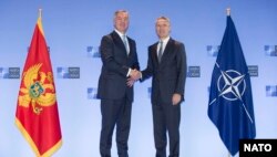 NATO secretary-general Jens Stoltenberg (R) meets with Montenegrin President Milo Dukanovic in Brussels, June 4, 2018