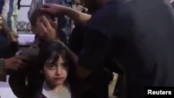A screen grab from a video circulated by activists showing children being treated for what appears to have been a chemical gas attack in Syria. (via Reuters)