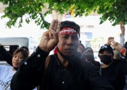 A Myanmar citizen shows a three-finger salute representing resistance to the military junta at a protest against the execution of pro-democracy activists at Myanmar's embassy in Bangkok, Thailand, on July 26, 2022. (Soe Zeya Tun/Reuters)