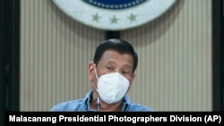 Philippine President Rodrigo Duterte wears a protective mask as he speaks on the new coronavirus situation of the country during a late night live broadcast from Malacanang, April 8, 2020.