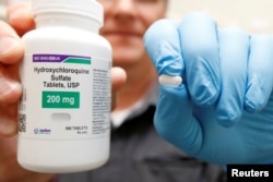 The drug hydroxychloroquine, pushed by U.S. President Donald Trump and others as a possible COVID-19 treatment, is displayed by a pharmacist at the Rock Canyon Pharmacy in Provo, Utah, U.S., May 27, 2020. REUTERS/George Frey/File Photo