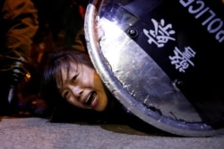 An anti-extradition bill protester is detained by riot police during a protest outside Mong Kok police station, in Hong Kong on September 2, 2019.