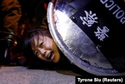 An anti-extradition bill protester is detained by riot police during a protest outside Mong Kok police station, in Hong Kong on September 2, 2019.